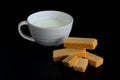 four wafer and cup of milk on black background with copy space Royalty Free Stock Photo