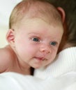 Four weeks old baby holding her head.