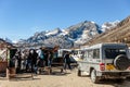 Four wheel drive cars parking area with tourists and floating market with Yunthang Valley in the background in winter.