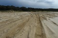 Four wheel drive tire marks in soft sand heading uphill Royalty Free Stock Photo