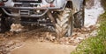 four - wheel drive truck is driving off-road. Close-up of the wheels. Traveling off-road. Royalty Free Stock Photo