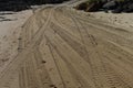 Four wheel drive tracks in sand leading to a ramp Royalty Free Stock Photo