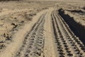 Four wheel drive tracks in soft sand at ground level with vanishing point Royalty Free Stock Photo