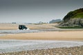 A four-wheel-drive in water between the sand dunes Royalty Free Stock Photo