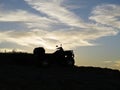 Four Wheeler Quad Bike Silhouette on Rock Cliff at Seaside during Beautiful Sunset Royalty Free Stock Photo