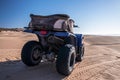 Four wheeler quadbike on sand at beach on bright sunny day Royalty Free Stock Photo