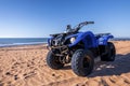 Four wheeler quadbike on sand at beach on bright sunny day Royalty Free Stock Photo