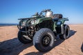 Four wheeler quadbike on sand at beach on bright sunny day Royalty Free Stock Photo