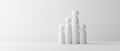 Four white abstract figures stand in a row against a white background Royalty Free Stock Photo