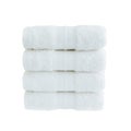 Four white bath towels in stack isolated over white