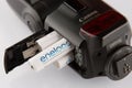 Four white batteries eneloop in flash canon isolated close up