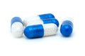 Four white-blue pills Royalty Free Stock Photo