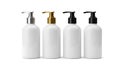 Four white bottles with different pump colors Royalty Free Stock Photo