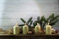 Four white burning candles on the fourth advent, christmas decor