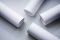 White cylindrical paper tubes scattered on a light gray surface Royalty Free Stock Photo