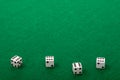Four White Dice on Green Felt Background Royalty Free Stock Photo