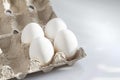 Four white Eggs In A Carton