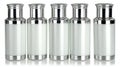 Four white glass bottles with silver caps, a pristine and versatile set for packaging Royalty Free Stock Photo