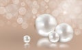 Four white pearls on peach shimmering light background