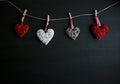 Four white and red hearts on black wooden table. Valentines, spring background. Mock up with copyspace. happy mothers day