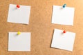 Four white stickers for taking notes on a cardboard background