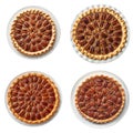 Four Whole Pecan Pies on White Plates Royalty Free Stock Photo