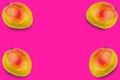 Four whole ripe mango in corners on pink background