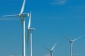 Four windturbines on blue sky Royalty Free Stock Photo