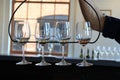 Four wine glasses in wrought iron holder, ready for tasting, Living Root Winery, Rochester, New York, 2017