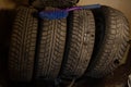Four winter tires for a car are not exactly in a row in storage. Low key Royalty Free Stock Photo
