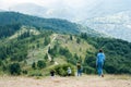 Four women come down the mountain. Tourists inspect the picturesque mountain landscape. Mountain trail along the ridge