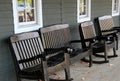 Four wood rocking chairs on front porch