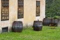 Four wooden barrels standing in the backyard of old house. In the background several Phoenix canariensis palms. Royalty Free Stock Photo