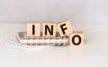 four wooden blocks with the letters info on the bright surface of a gray table, business concept. Royalty Free Stock Photo