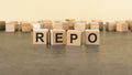 four wooden blocks with the letters REPO - on the surface table. REPO - Repurchase Agreement