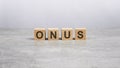 four wooden blocks with the word ONUS on the gray table. business concept Royalty Free Stock Photo