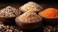 Four wooden bowls of different spices on a dark wooden surface Royalty Free Stock Photo