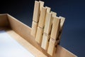 Four wooden clothespins on a gift box.