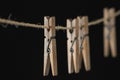 Four wooden clothespins on a wire