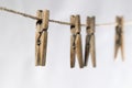 Four wooden clothespins on a wire