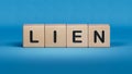 Four wooden cubes arranged in stack with word LIEN on them, space for text. Royalty Free Stock Photo