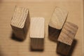 Four wooden cubes, standing on packing paper background Royalty Free Stock Photo