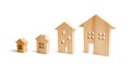 four wooden houses stand in ascending order on a white background. Isolate The concept of increasing population density