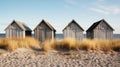 Four wooden huts on a sandy beach on a sunny day Royalty Free Stock Photo