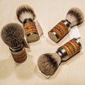 Four wooden shaving brushes on the canvas Royalty Free Stock Photo