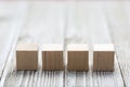 Four wooden toy cubes on grey wooden background Royalty Free Stock Photo