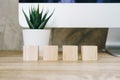 Four wooden toy cubes on wooden table background with copy space Royalty Free Stock Photo