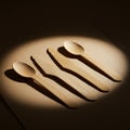 Four wooden utensils are arranged side by side on a light surface. The set includes Royalty Free Stock Photo