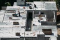 Four workers on the top floor of the building are installing concrete floors