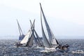 Yachts crossing each other and racing into the wind.